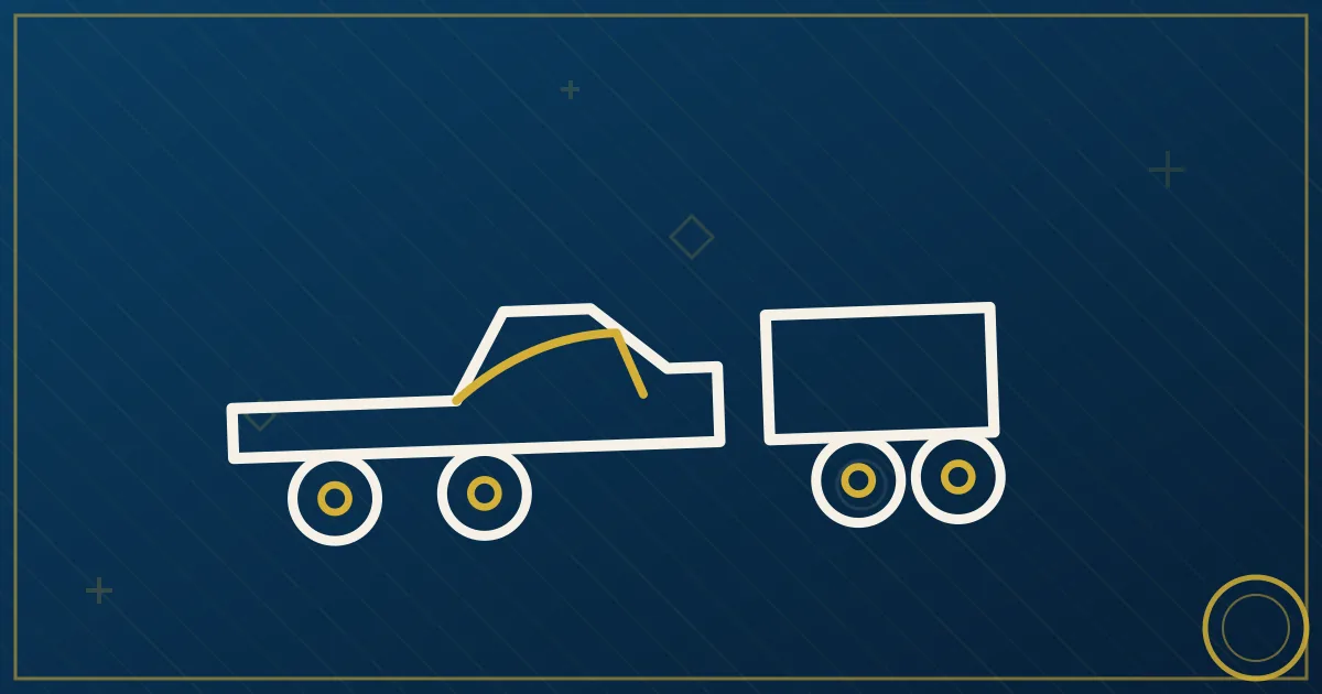 Heavy-duty dually pickup towing a gooseneck flatbed trailer with urgent expedite freight at dawn