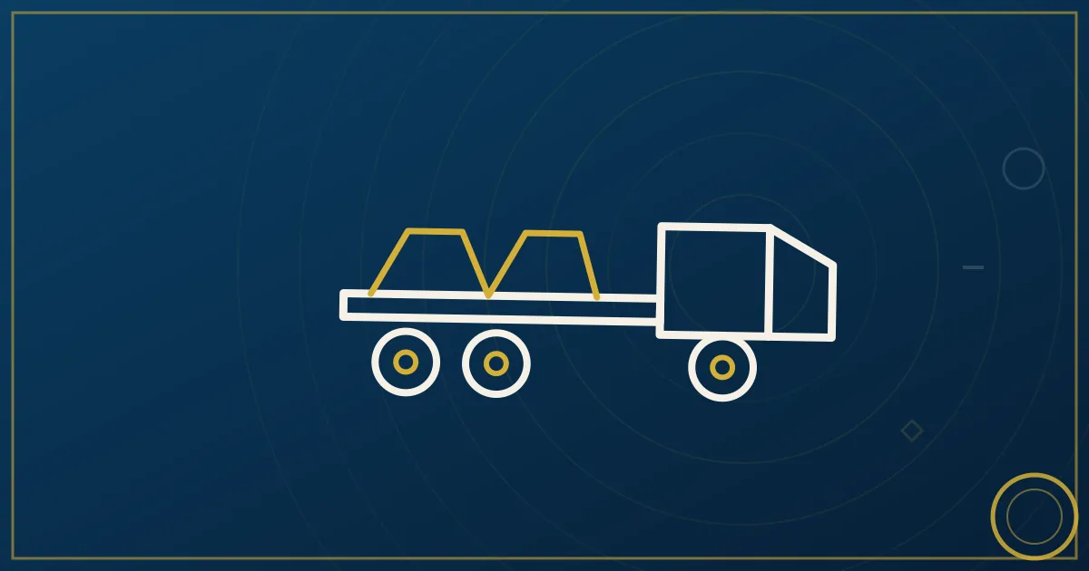 Flatbed semi trailer loaded with lumber and secured with straps and tarps at a lumber yard