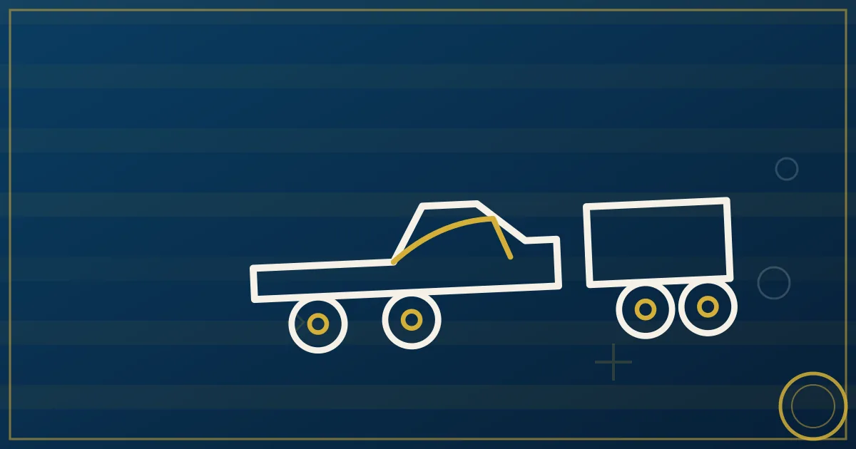 Pickup truck with gooseneck flatbed trailer loaded with equipment on a rural highway