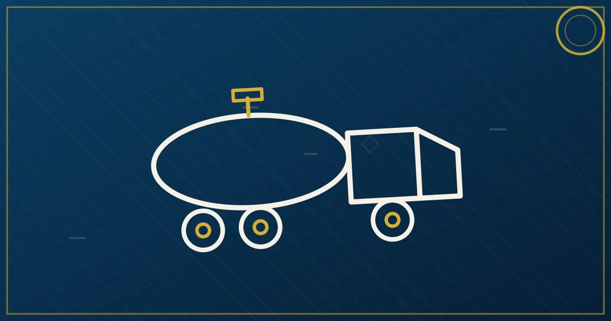 Stainless steel tanker trailer at a loading facility with hoses connected