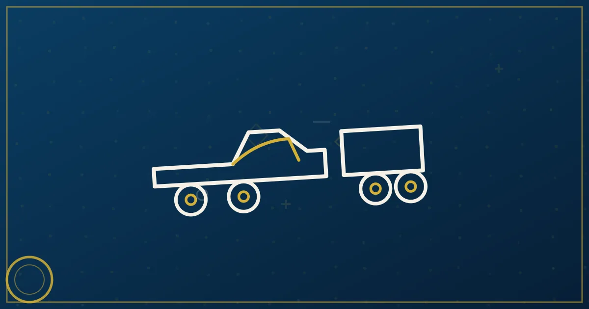 White dually pickup truck towing a loaded gooseneck flatbed trailer on a highway, illustrating hotshot trucking operations