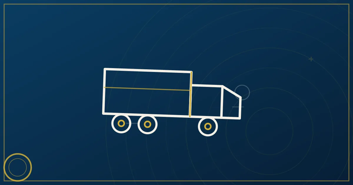Owner-operator standing beside a blue semi-truck at a truck stop, illustrating the path to becoming an owner-operator