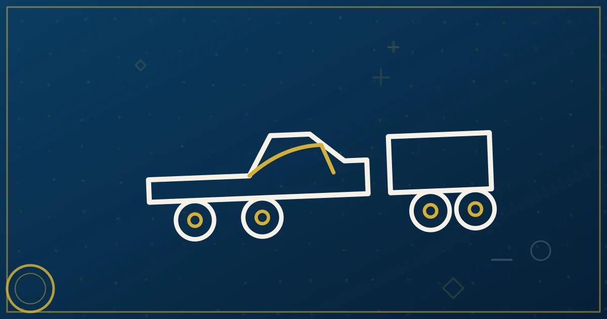 Pickup truck pulling a gooseneck flatbed trailer loaded with secured equipment