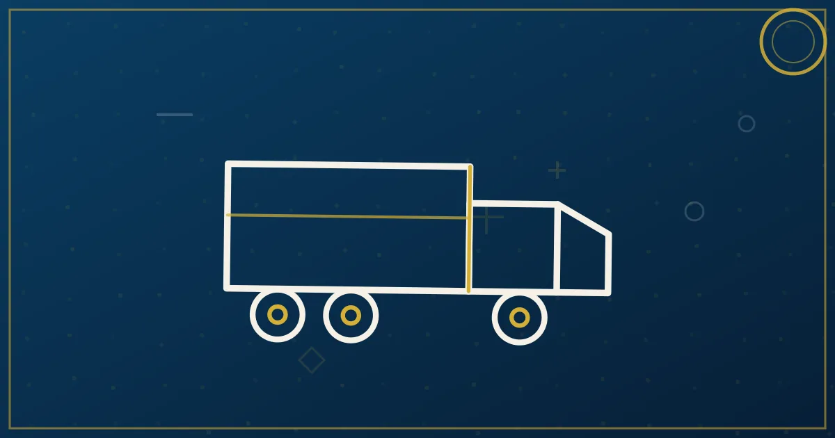 Semi tractor hooked to a shipping company trailer at a distribution center drop lot at dawn