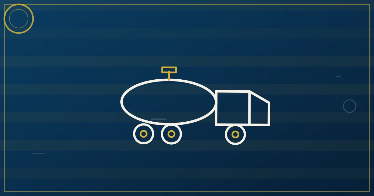 Stainless steel tanker trailer at a loading rack with hoses connected during a liquid transfer