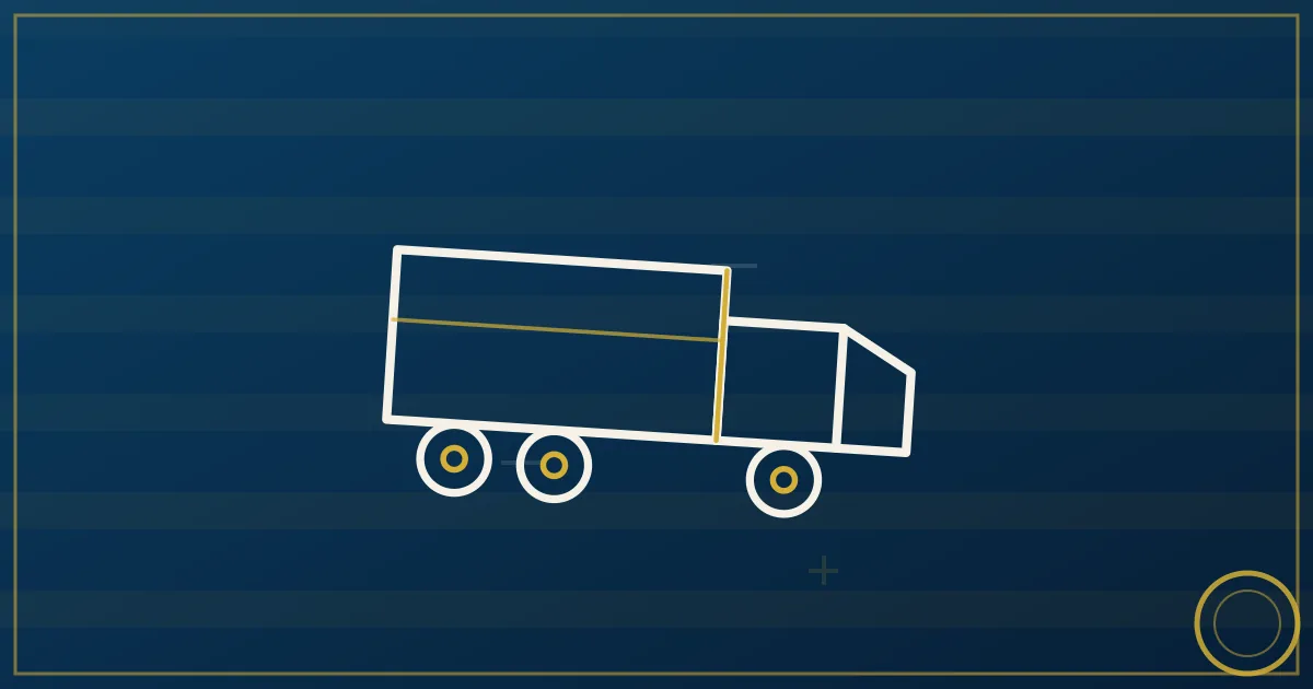 Freight broker office desk with shipping documents and a laptop in lapis blue and gold tones